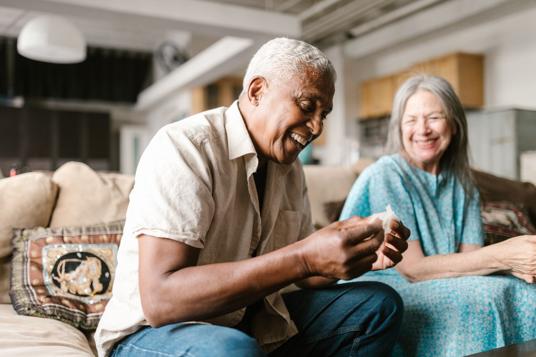 A smiling older couple relaxing together at home